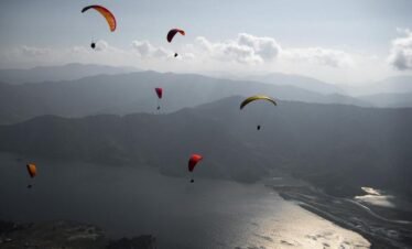 Paragliding over Pokhara with views of Phewa Lake and the Himalayas