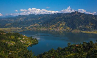 Phewa Lake in Pokhara during morning with Himalayan mountains reflected in the water